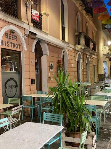a restaurant with tables and chairs in front of a building at Bobo’s Home in Iglesias