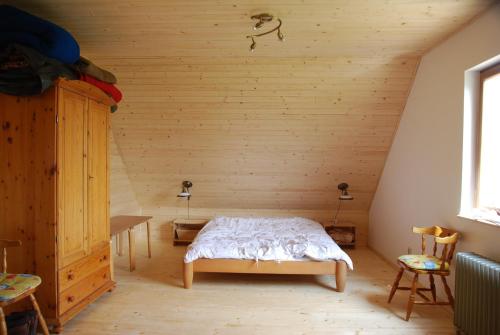 um quarto com uma cama num quarto de madeira em Villa Dalski em Piechowice