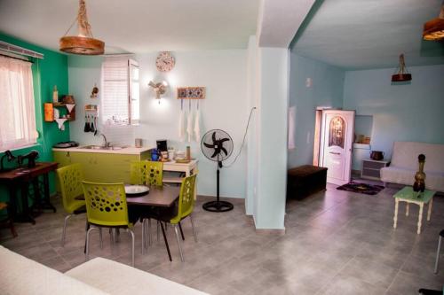 a kitchen and living room with a table and chairs at Traditional house Utopia Makri Gialos in Pévkoi