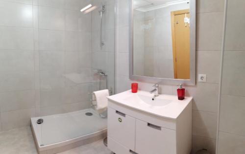a white bathroom with a sink and a mirror at T2 Apt-Beachtour Lux Sunset - Ericeira in Ericeira