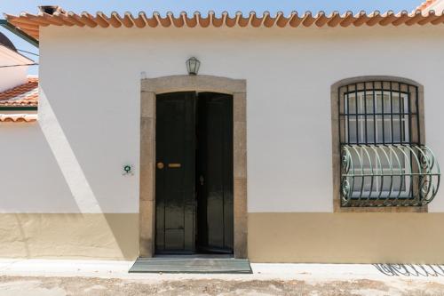 a white door leading to a small room with a white door at Casa De Casal De Loivos in Casal de Loivos