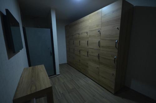 a room with wooden drawers and a wooden table at Snowflake Dag Hotel & SPA in Sarıkamıs