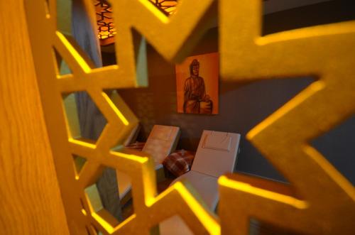 a room with a bed and a picture of a man at Snowflake Dag Hotel & SPA in Sarıkamıs