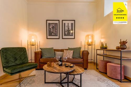 a living room with a couch and a table at Guesthouse Westende in Middelkerke
