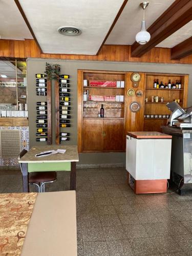 a kitchen with a counter and a table in a room at Hotel Belgrano in Perito Moreno