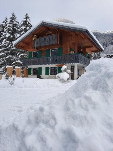 a large snow pile in front of a house at Chalet la sapiniere in La Chapelle-dʼAbondance