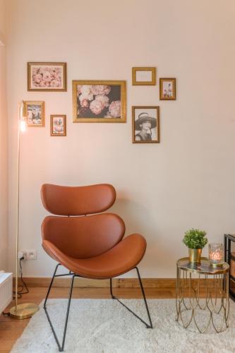 a brown chair in a living room with a table at Guesthouse Westende in Middelkerke