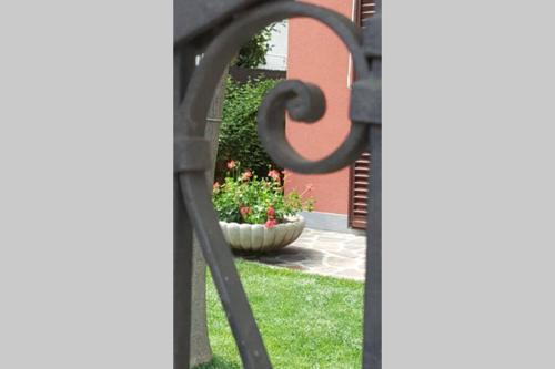 a view of a garden through a metal gate at Casa Emel in Potenza Picena