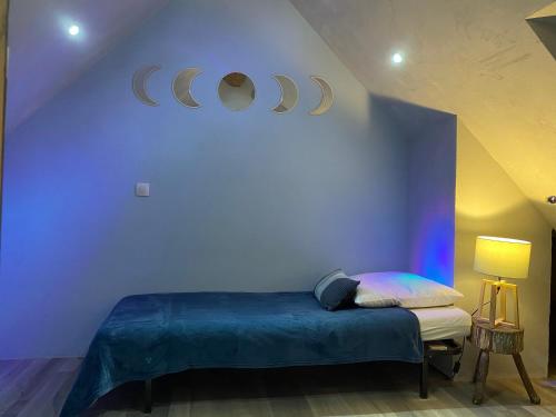 a room with a bed with planets on the wall at VENOSC Le Haut de la Grange in Les Deux Alpes