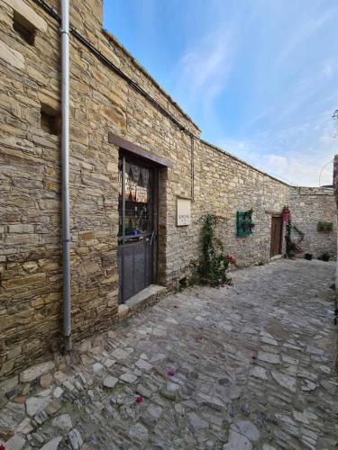 a brick building with a window on the side of it at Christiana's stone studios in Pano Lefkara