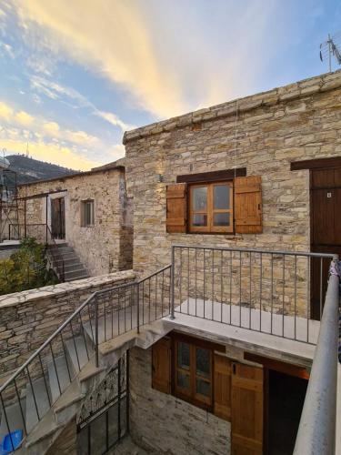 a stone building with a staircase and a balcony at Christiana's stone studios in Pano Lefkara