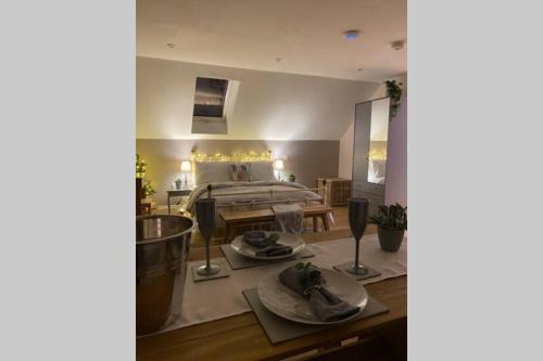 a room with a bed and a table with dishes on it at Prospect Perch - Studio Apartment, Wells in Wells