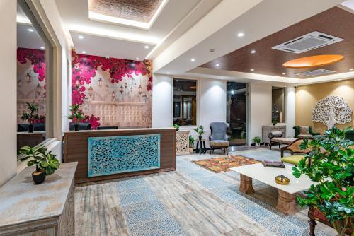 a lobby with a large tv in the middle at Anand Bagh Resort & Spa by Ananta in Sālāsar