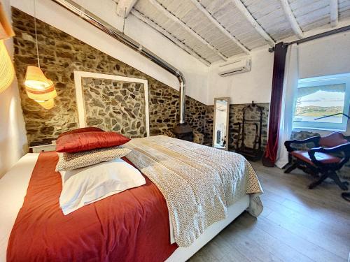a bedroom with a bed and a window at Monte Do Malhao - Art, Eco & Spa in Castro Marim