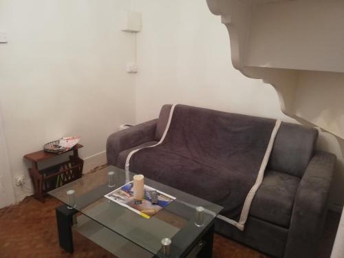 a living room with a couch and a glass table at Fouettara in Firminy