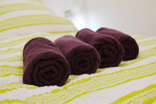 a group of purple towels on a bed at Apartmán 466 in Rokytnice nad Jizerou