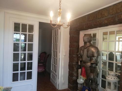a statue of a man standing next to a door at Fouettara in Firminy
