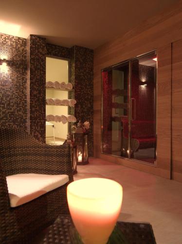 a room with a chair and a lamp and a mirror at Hotel Natura in Castel di Sangro