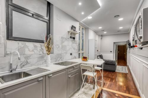 a kitchen with a sink and a counter at ATRHOME Frattina Luxury in Rome