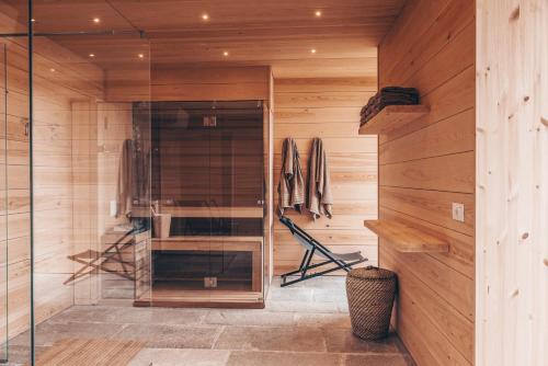 a sauna with wooden walls and a glass door at Casa Rampolina in Stresa