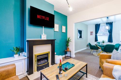 a living room with a fireplace and a tv at Smart home near Chester City Centre in Chester