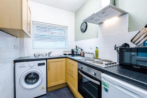 a kitchen with a washing machine and a washer at Smart home near Chester City Centre in Chester