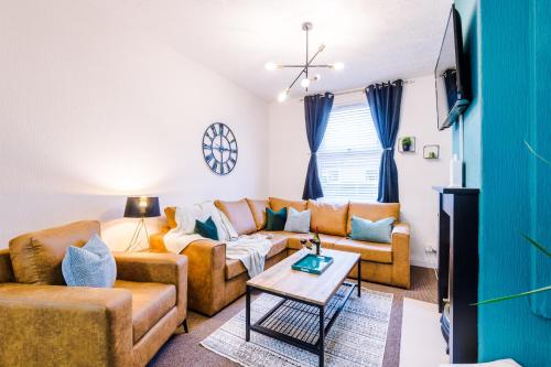 a living room with a couch and a table at Smart home near Chester City Centre in Chester