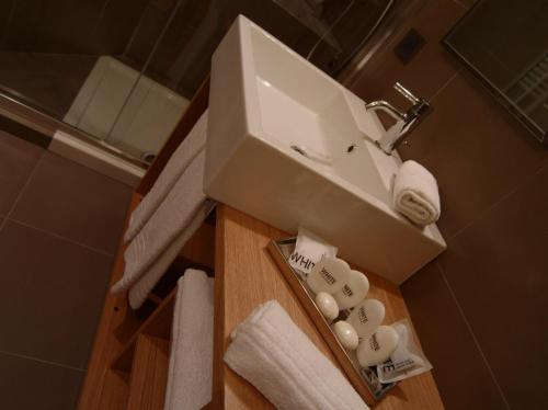 a bathroom with a sink and towels on a counter at Hotel Natura in Castel di Sangro