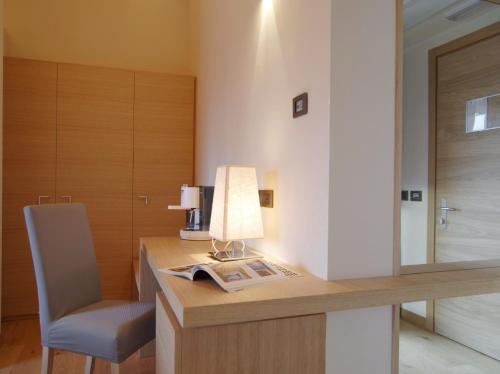 a desk with a lamp and a chair in a room at Hotel Natura in Castel di Sangro
