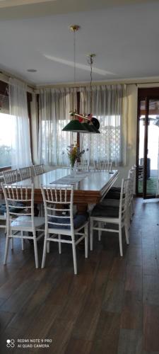 a dining room with a white table and chairs at Vila Orešac in Smederevo