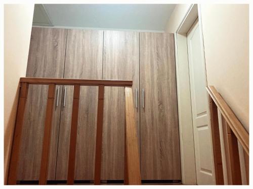 a closet with wooden cabinets in a room at Vila Jelena, Tara in Kaludjerske Bare