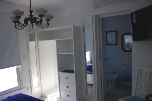 a bedroom with a white bunk bed with a mirror at Allegra Dalila Casa Hotel-Arte in Tandil