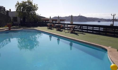 a large blue swimming pool with a view of the water at Mistral La Herradura in Coquimbo