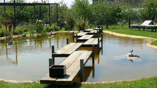 a row of wooden docks in a pond with ducks at Las Villas de Cué in Llanes