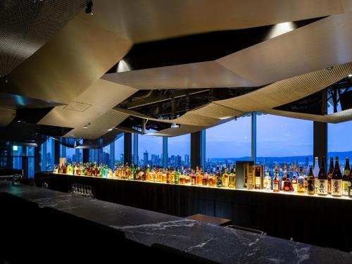 a bar with a lot of bottles of alcohol at Hotel Royal Classic Osaka in Osaka