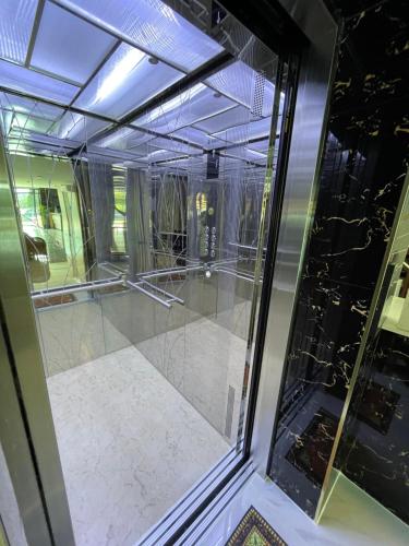 an empty room with a glass door and a floor at Napa Hotel Ratchaburi in Ratchaburi