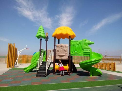 a childrens playground with a green slide at Apartamento con vista a Islas Ballestas in Paracas