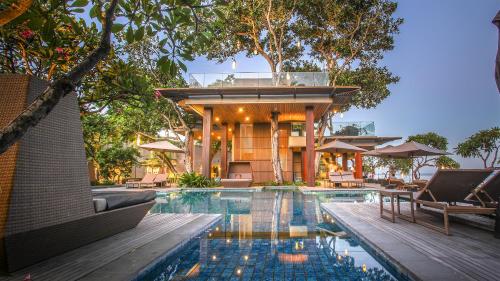 a pool with a pool table and chairs in it at Maya Sanur Resort & Spa in Sanur