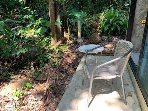 a table and two chairs sitting on a porch at BeachBox@Koh Сhang in Ko Chang