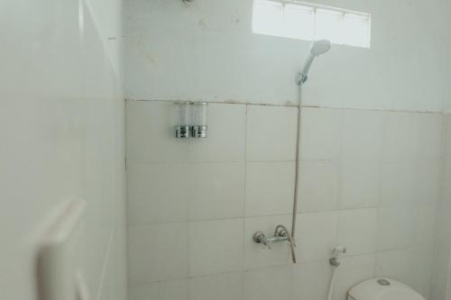 a bathroom with a shower and a toilet at Sekar Arum Riverside Resort in Canggu in Tanah Lot