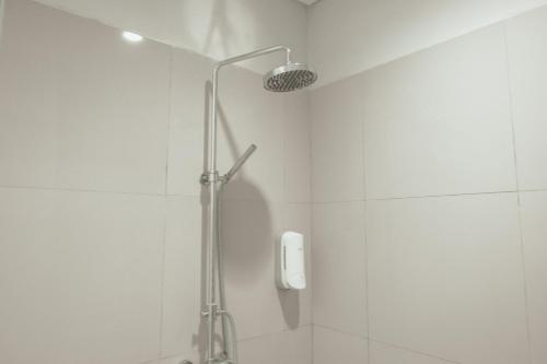 a shower with a shower head in a bathroom at Sekar Arum Riverside Resort in Canggu in Tanah Lot