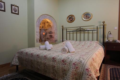 a bedroom with a bed with two towels on it at Polyxenia Hotel in Nafplio