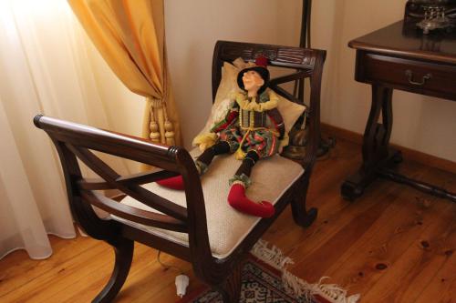a doll sitting on a chair in a room at Polyxenia Hotel in Nafplio