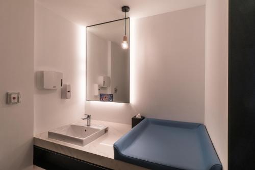 a bathroom with a sink and a mirror at Evergreen Palace Hotel Chiayi in Taibao