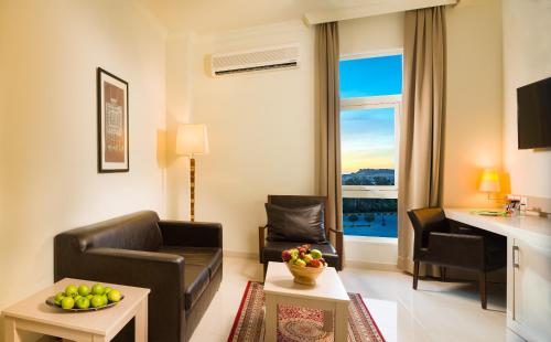 a living room with a couch and a table at City Hotel Duqm in Duqm