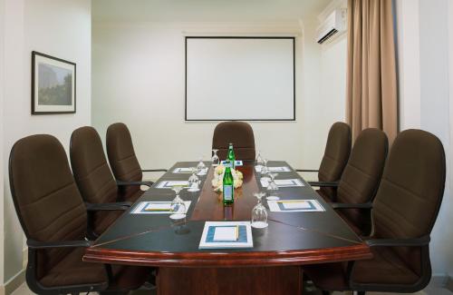 a conference room with a long table and chairs at City Hotel Duqm in Duqm