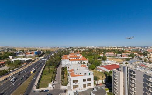 an overhead view of a city with a road and buildings at Radisson Blu Hotel Lisbon in Lisbon