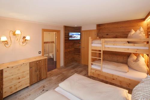 a bedroom with two bunk beds and a bathroom at Gästehaus Trixl in Zell am See