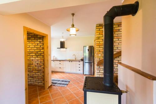 a kitchen with a stove in a room at Dolina Biebrzy - Chata Retmana in Wroceń