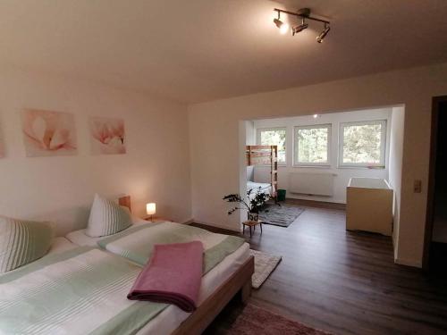 a bedroom with two beds and a large window at KiEZ Am Filzteich in Schneeberg